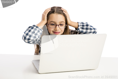 Image of Little girl working with a laptop