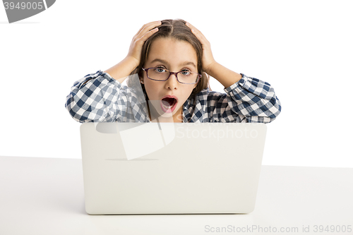 Image of Little girl working with a laptop