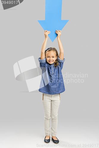 Image of Girl holding a big blue arrow