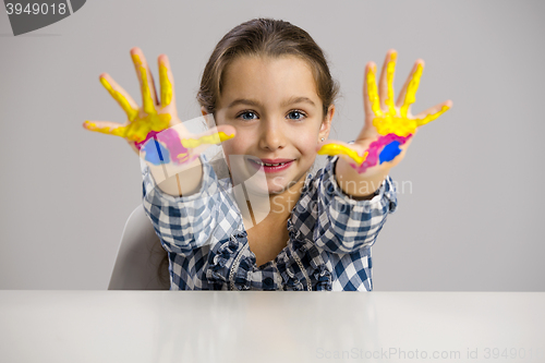 Image of Little girl with hands in paint