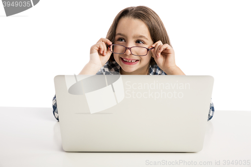Image of Little girl working with a laptop