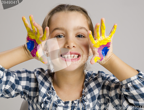 Image of Little girl with hands in paint