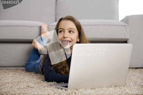 Image of Little girl working with a laptop