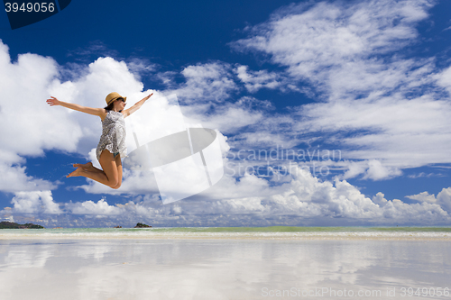 Image of Beautiful woman jumping at the beach