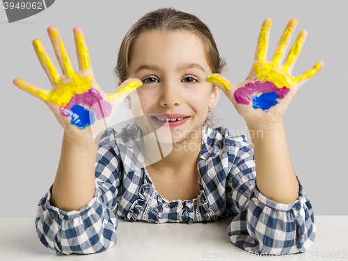 Image of Little girl with hands in paint