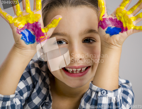 Image of Little girl with hands in paint