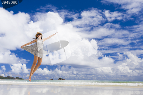 Image of Beautiful woman jumping at the beach