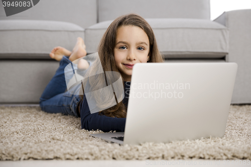 Image of Little girl working with a laptop