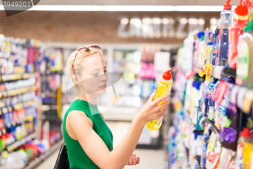 Image of Woman shopping cleaners at supermarket.