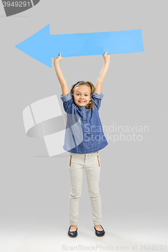 Image of Girl holding a big blue arrow