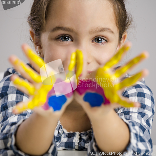 Image of Little girl with hands in paint