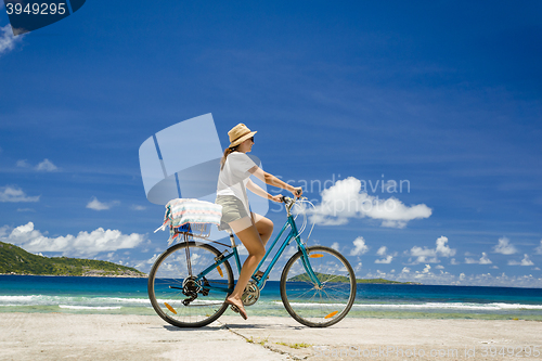 Image of Woman ride along The Beach