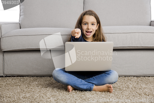Image of Little girl working with a laptop