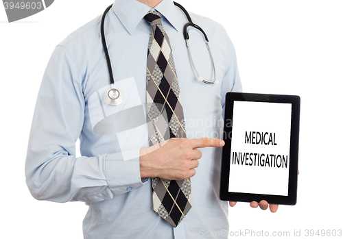 Image of Doctor holding tablet - Medical investigation