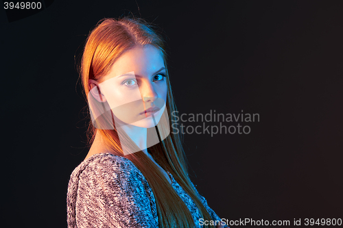 Image of Side view portrait of red haired girl looking forward