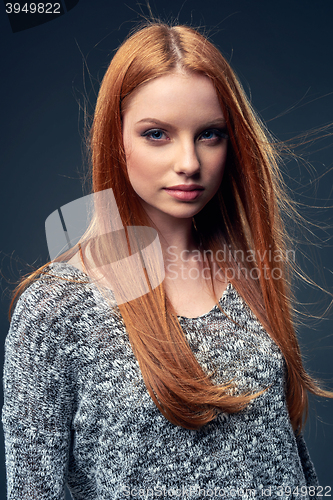 Image of Beautiful red haired female in grey sweater