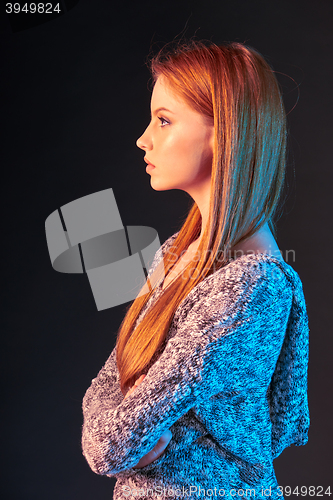 Image of Side view portrait of red haired girl looking forward