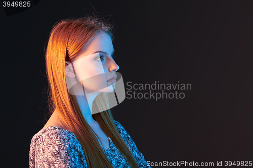 Image of Side view portrait of red haired girl looking forward
