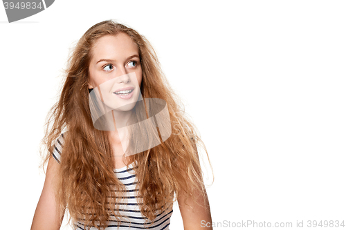 Image of Excited teen girl looking to the side in amazement.