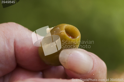 Image of hand with an olive