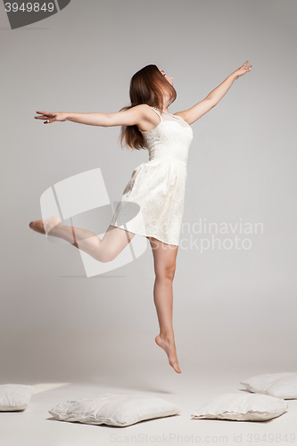 Image of Flying brunette in white dress