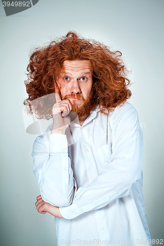 Image of Portrait of young man with shocked facial expression