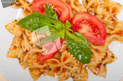 Image of Italian pasta farfalle butterfly bow-tie and tomato sauce