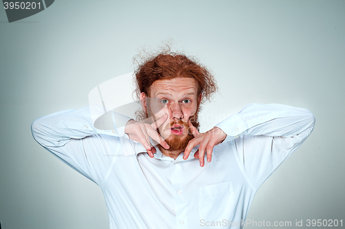 Image of Portrait of young man with shocked facial expression