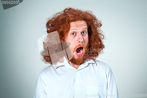 Image of Portrait of young man with shocked facial expression