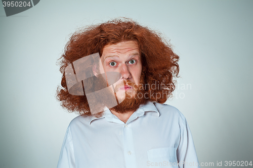 Image of Portrait of young man with shocked facial expression