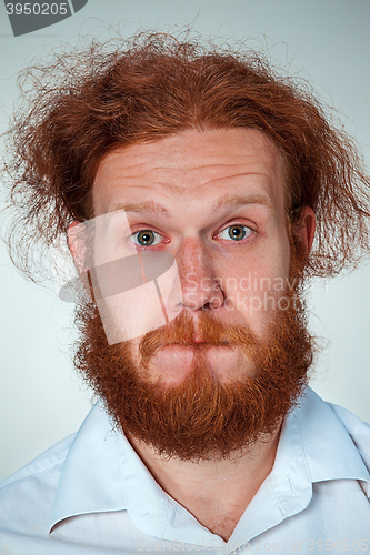 Image of Portrait of young man with shocked facial expression