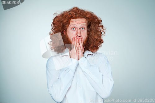 Image of Portrait of young man with shocked facial expression