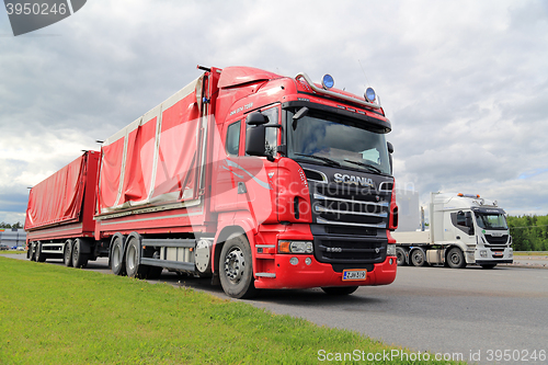 Image of Red Scania, Green Grass, Grey Sky