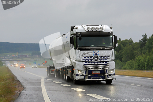 Image of White Mercedes-Benz Actros Tank Truck Trucking in Rain