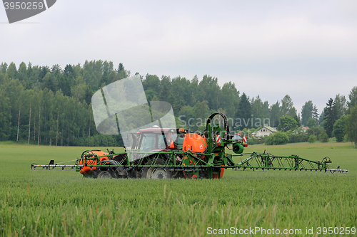 Image of Tractor and Mounted Sprayer on Wheat Field