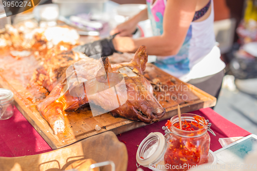 Image of Roasted suckling pig served on food stall.