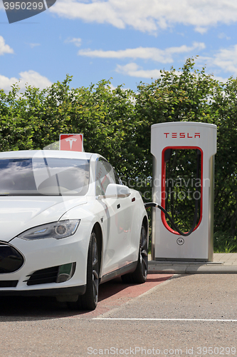 Image of White Tesla Model S Electric Car Charging Battery