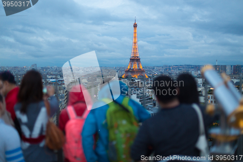 Image of Tourist taking photos of Paris cityscape with Eiffel tower.