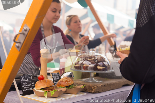 Image of Women serving hamburgers on food festival in Ljubljana, Slovenia.