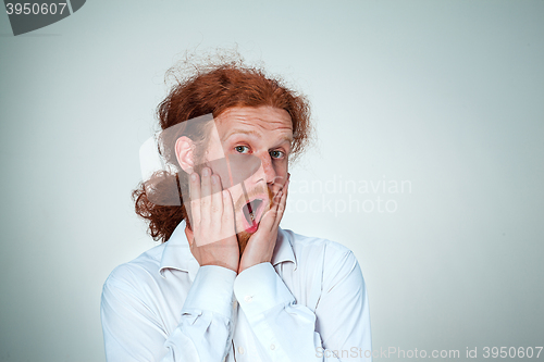 Image of Portrait of young man with shocked facial expression