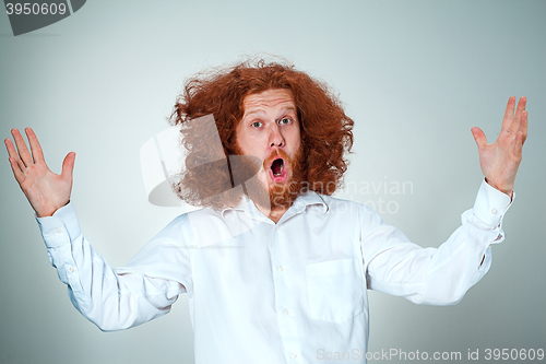 Image of Portrait of young man with shocked facial expression