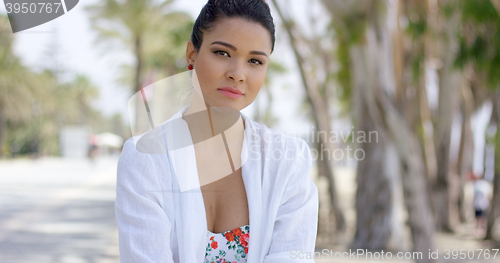 Image of Confident woman in tropical beach scene