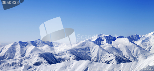 Image of Panoramic view on snowy winter mountains and blue sky