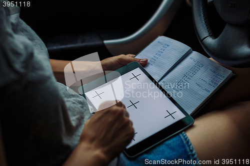 Image of woman with a tablet looking into Notepad