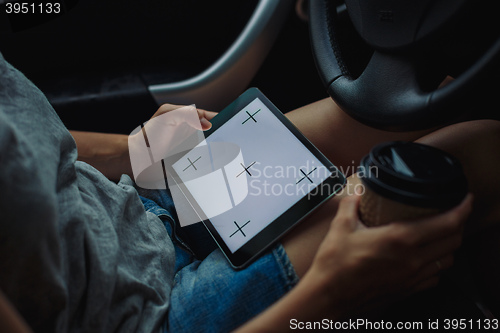 Image of woman with tablet in the car