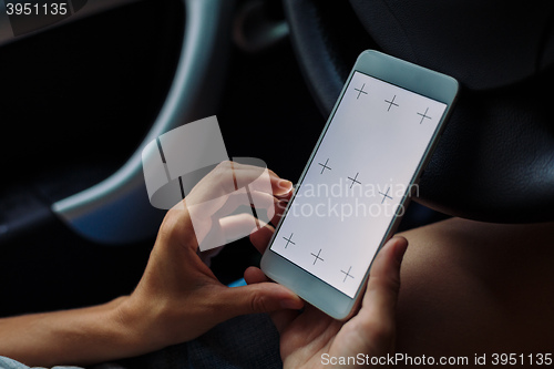 Image of woman with the phone in the car