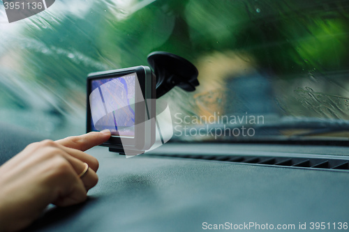 Image of woman looks at a GPS Navigator in the car