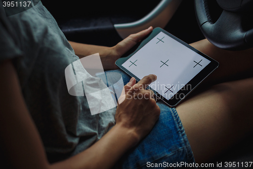 Image of woman with tablet in the car