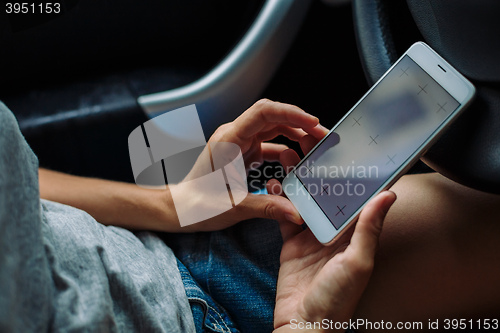 Image of woman with the phone in the car