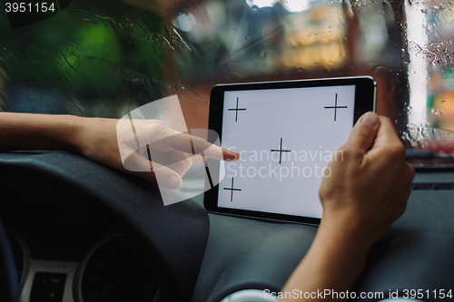 Image of woman with tablet in the car